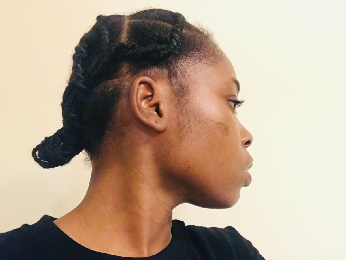 A woman showing of her threating hairstyle.